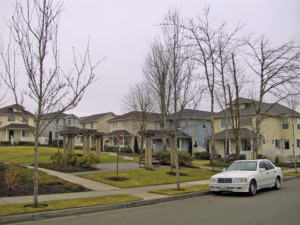 A street of two story single family homes with front porches in the Northwest Landing neighborhood of DuPont, Washington