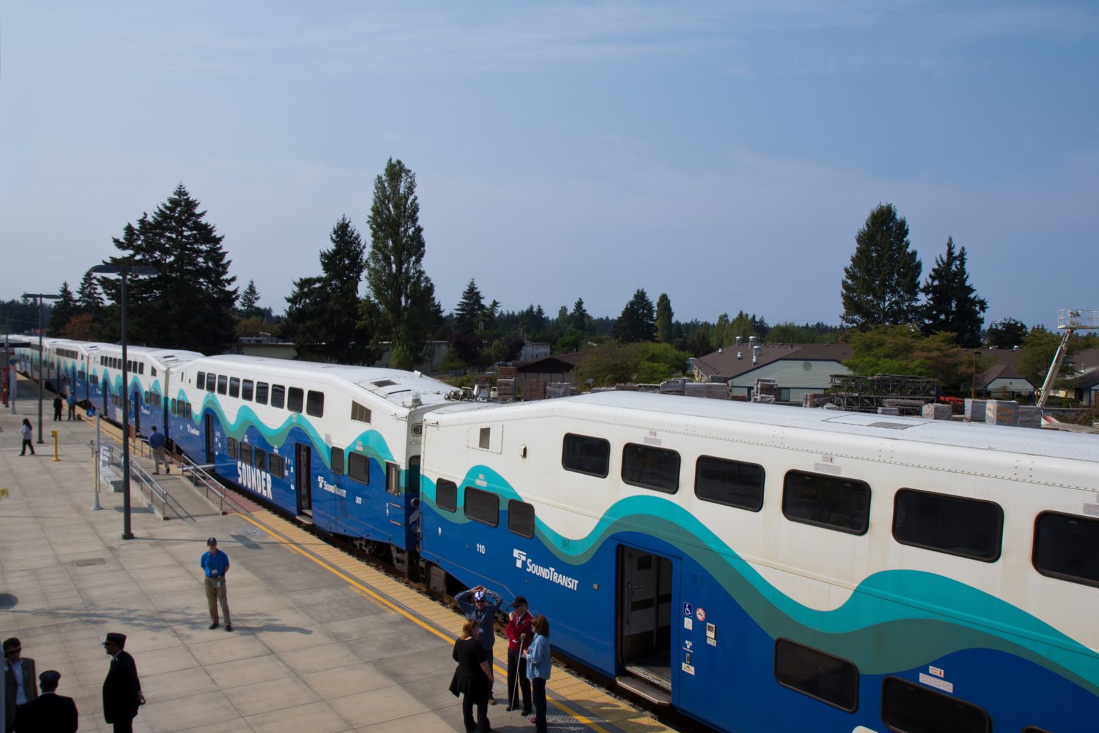 Sounder commuter trains at the platform at Lakewood Station in Lakewood, Washington, with riders waiting to board