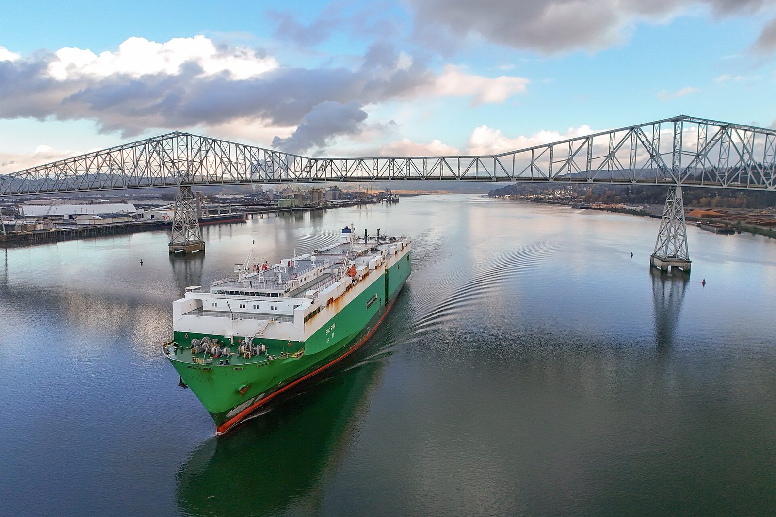 A car carrier ship passing under the Lewis and Clark Bridge over the Columbia River at Longview, Washington
